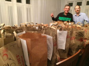 Carl and Jon with donated bags of food