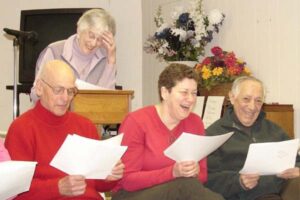 Laughing Temple Emanu-El members reading from a script