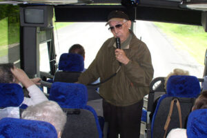 Bert telling jokes at the front of the bus to Oswego