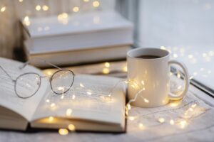 Books, a cup of tea, and a pair of glasses